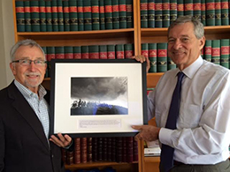 Mark Gibson (left) receives a photograph from Samuel L. "Tony" Milbank, Chair of the Board of the Milbank Memorial Fund, (right), in celebration of his retirement.