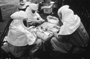 CDC and Zairian scientists take blood samples near Kikwit, Zaire, during the 1995 Ebola virus outbreak. CDC/Ethleen Lloyd.