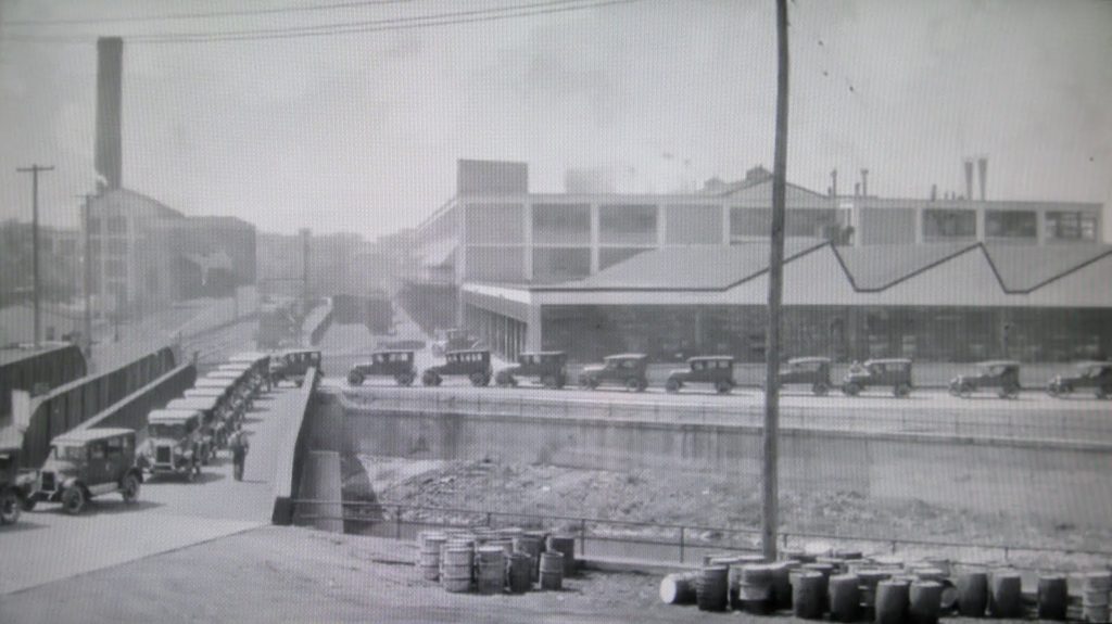 1925 Chevrolet models leaving the plant and crossing the Flint River.