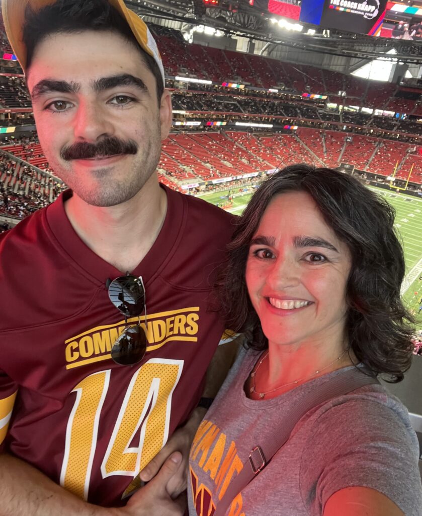 Deb Lubar and son at Commanders game.
